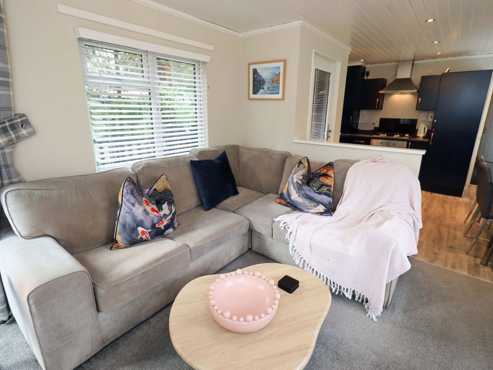 A living room with a sofa and coffee table at Evermore Lodge, 48 Calgarth Park, White Cross Bay, Windermere