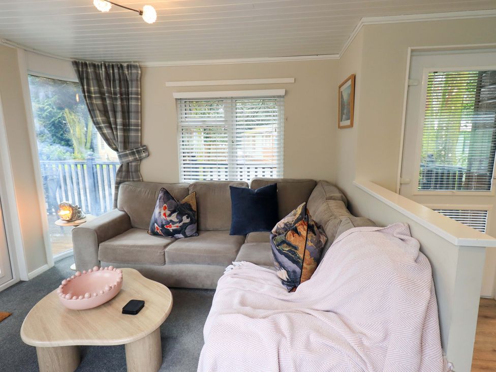 A living room with a sofa and coffee table at Evermore Lodge 48 Calgarth Park, White Cross Bay, Windermere