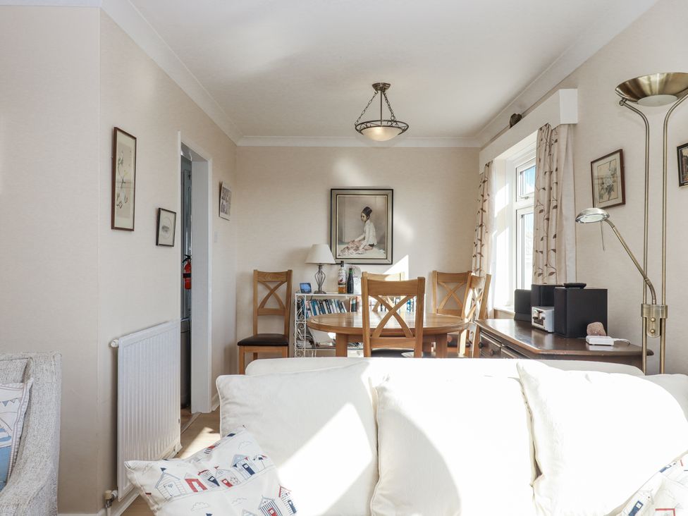 A dining room with a table and chairs at Woodbury in Teignmouth