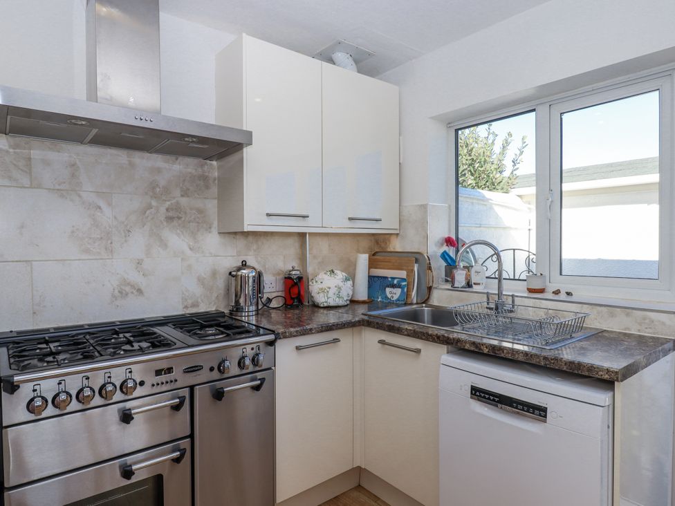 A kitchen with a stove and sink at Woodbury in Teignmouth