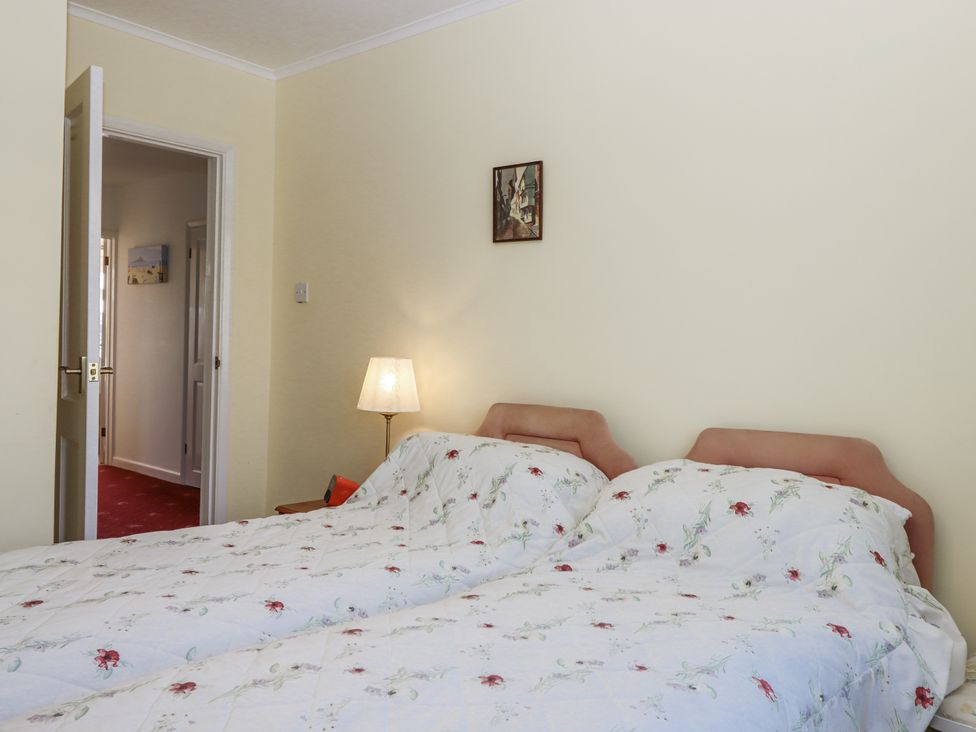 A bedroom with two beds and a lamp at Woodbury in Teignmouth