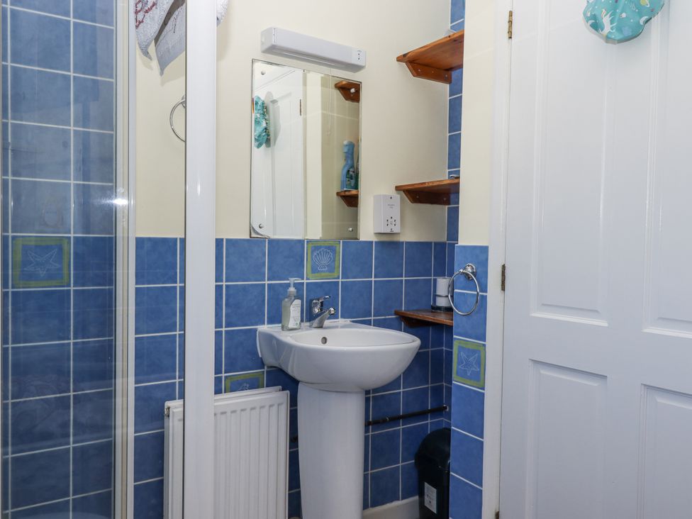 A bathroom with a sink and mirror at Woodbury in Teignmouth