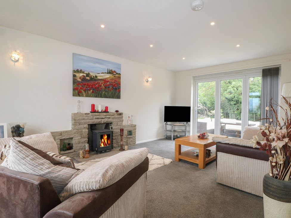 A living room with sofas and a fireplace at Walmer Court Farmhouse in Deal