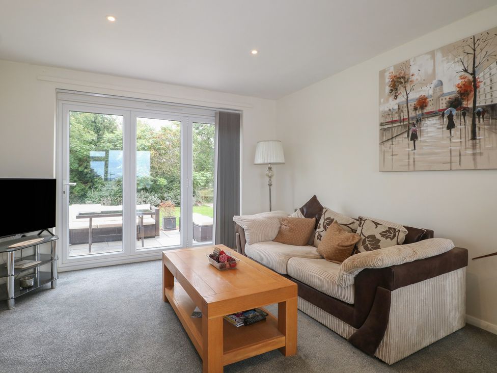 A living room with a sofa and coffee table at Walmer Court Farmhouse in Deal