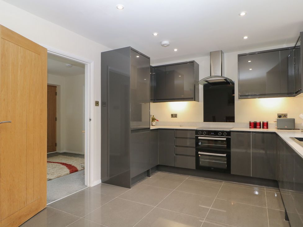A kitchen with cabinets and an oven at Walmer Court Farmhouse in Deal