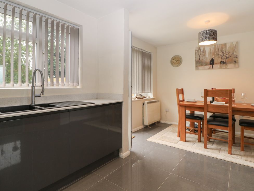 A kitchen with a sink and dining area at Walmer Court Farmhouse in Deal
