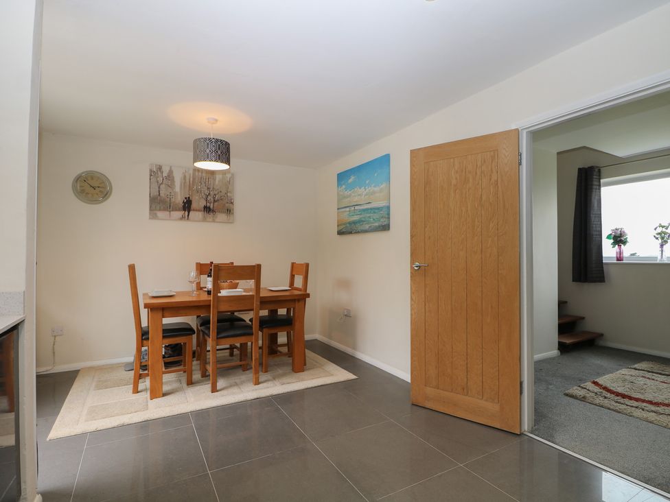 A dining room with a table and chairs at Walmer Court Farmhouse in Deal