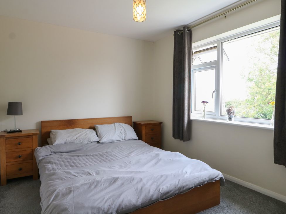 A bedroom with a bed and nightstands at Walmer Court Farmhouse in Deal