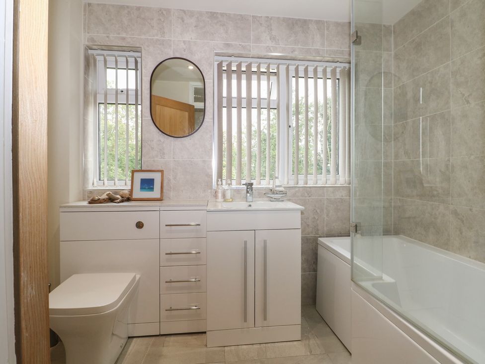 A bathroom with a sink and bathtub at Walmer Court Farmhouse in Deal