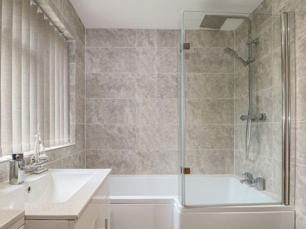 A bathroom with a bathtub and shower at Walmer Court Farmhouse, Deal