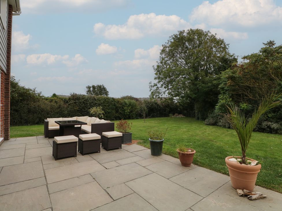 A patio area with outdoor furniture at Walmer Court Farmhouse in Deal