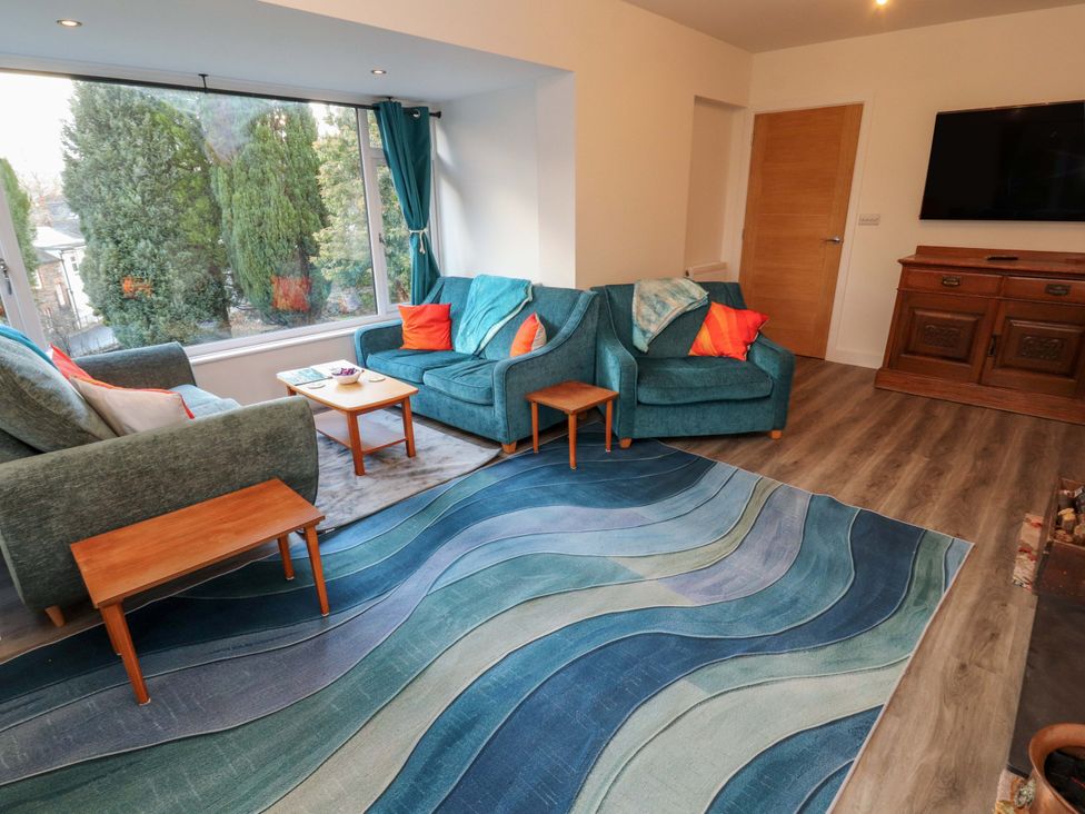 A living room with sofa, armchair and coffee table at Westerlodge Threlkeld near Keswick