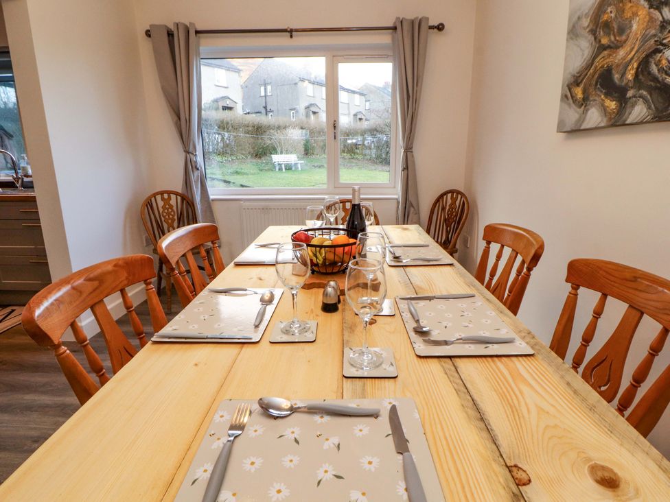 A dining room with a table set for meals at Westerlodge in Threlkeld near Keswick