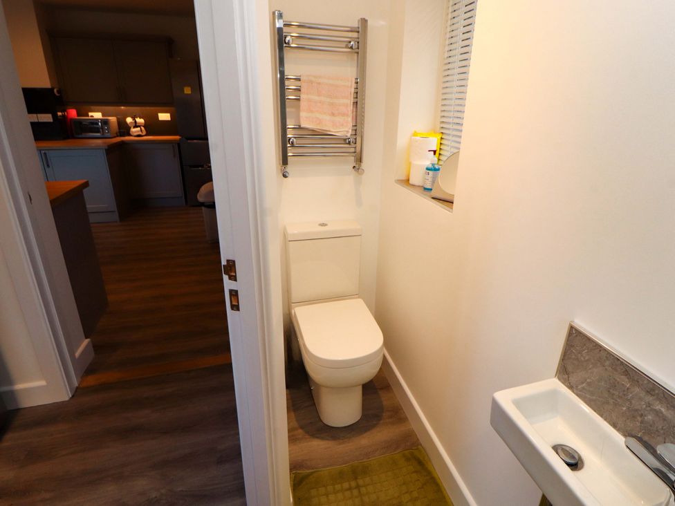 A bathroom with a toilet and sink at Westerlodge Threlkeld near Keswick