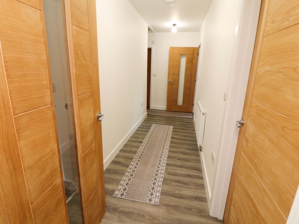 A hallway with doors and a rug at Westerlodge Threlkeld near Keswick