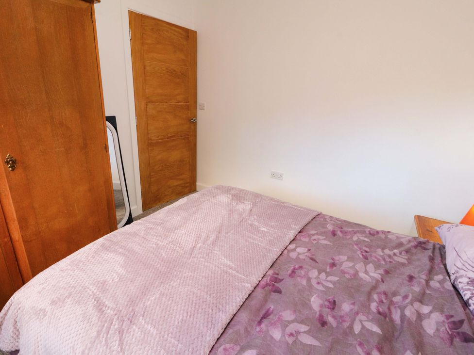 A bedroom with a bed and wardrobe at Westerlodge Threlkeld near Keswick