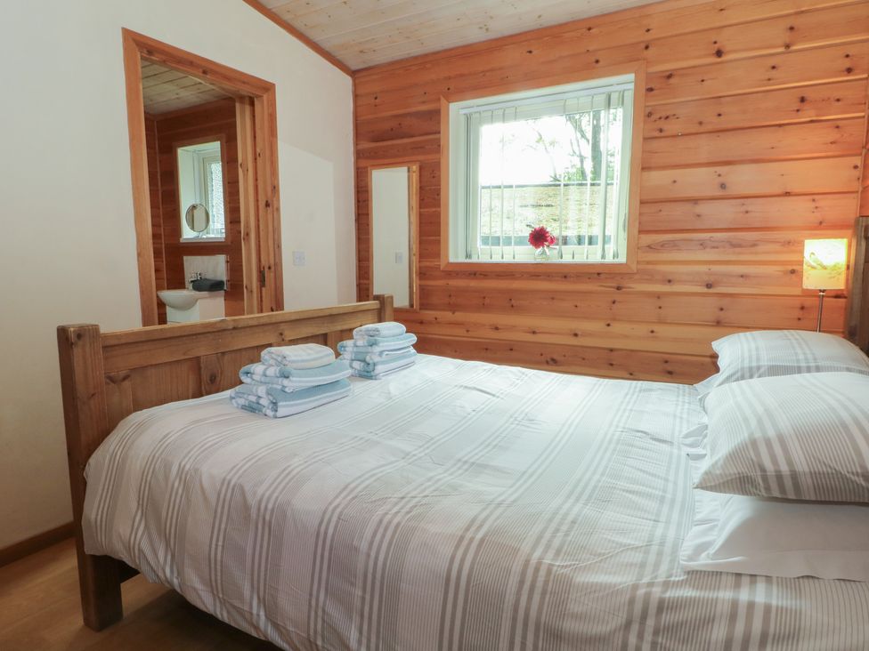 A bedroom with a bed and towels at Woodlands View in Leek