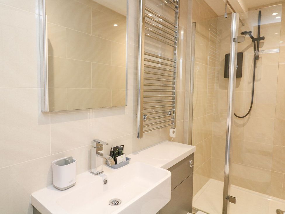 A bathroom with a sink and shower at Quay cottage Salcombe