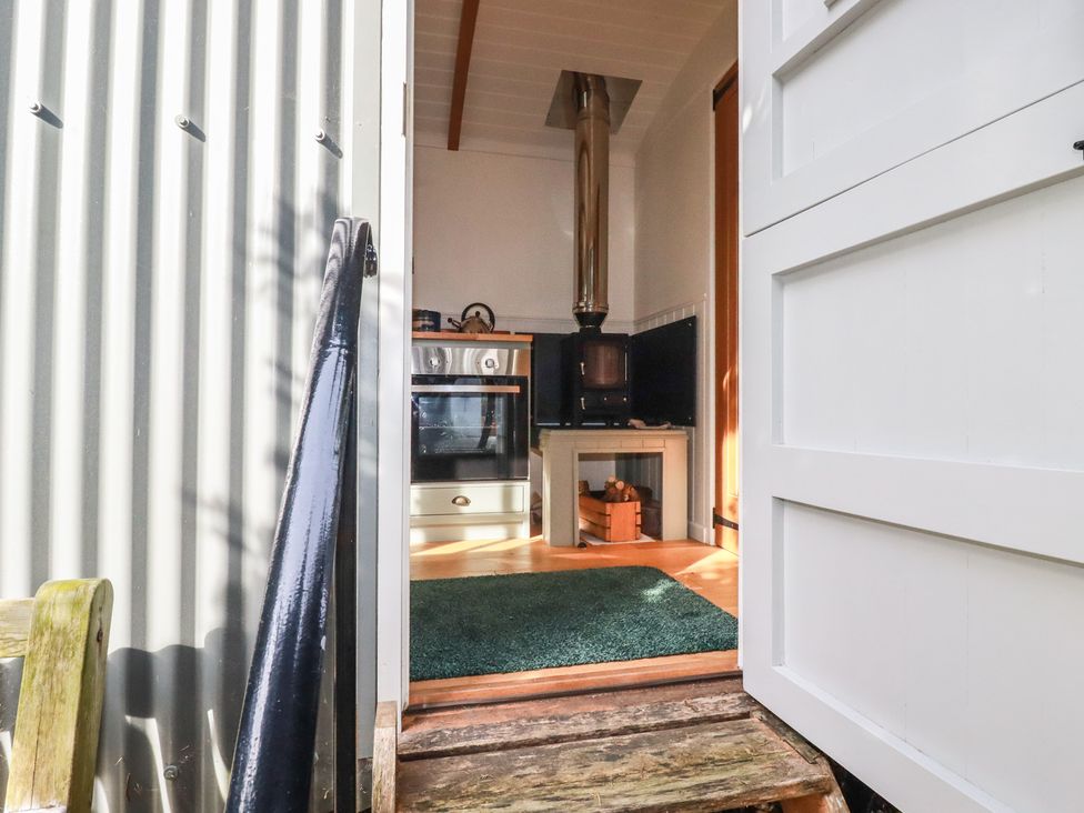 A kitchen with a stove and oven at Hillbre Shepherd Hut in Padstow