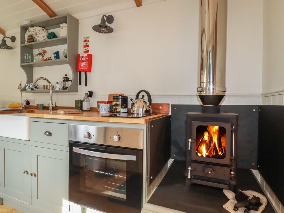 A kitchen with oven and wood stove at Hillbre Shepherd Hut, Padstow