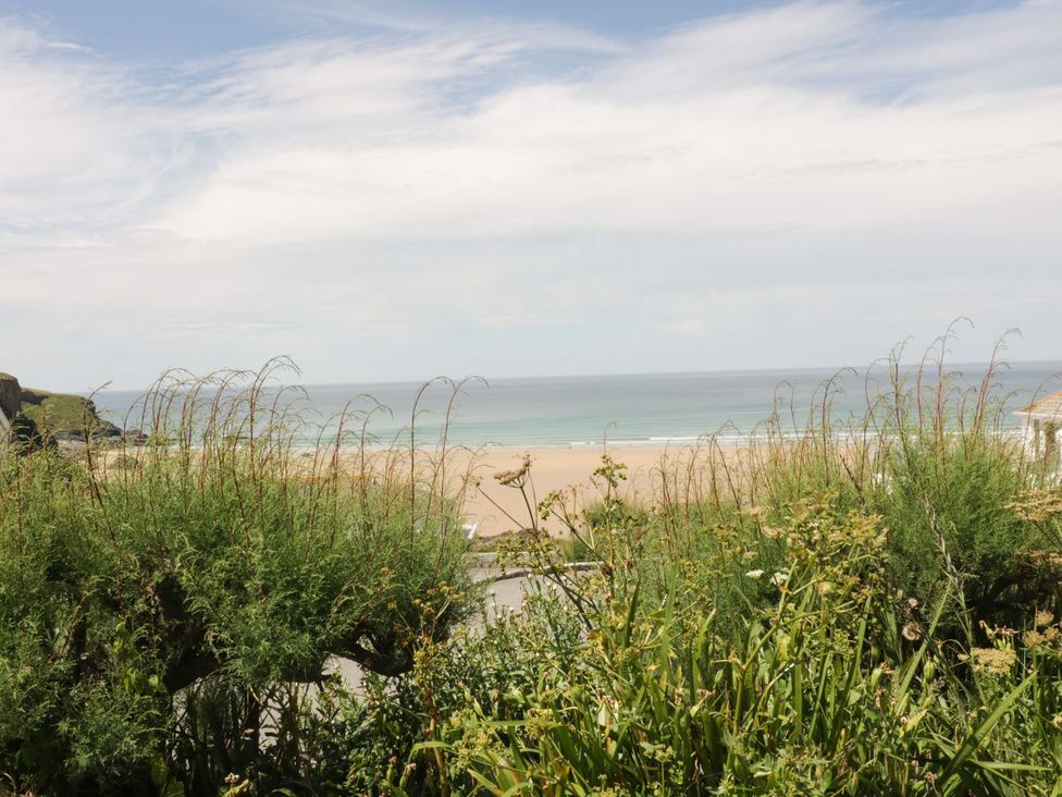 A beach view with ocean and grass at Hillbre Shepherd Hut in Padstow