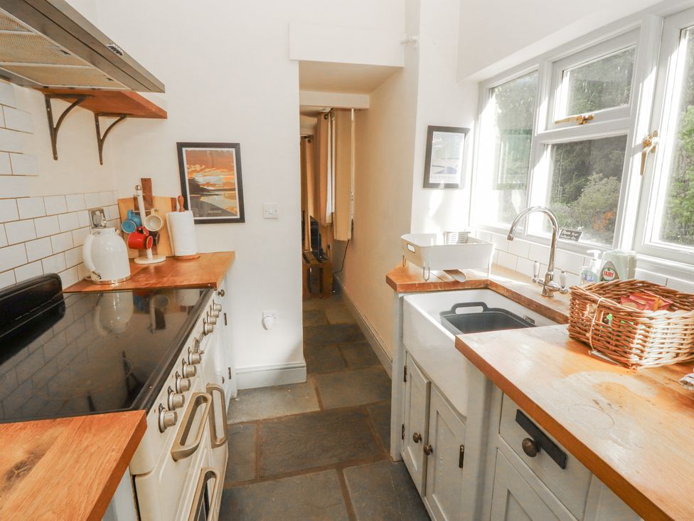 A kitchen with an oven, sink, and countertop at Rock Cottage in Milnthorpe