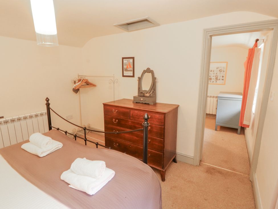 A bedroom with a bed and drawers at Rock Cottage in Milnthorpe