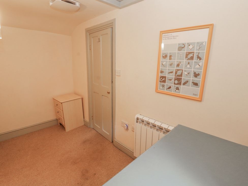 A room with a drawer unit and wall art at Rock Cottage in Milnthorpe
