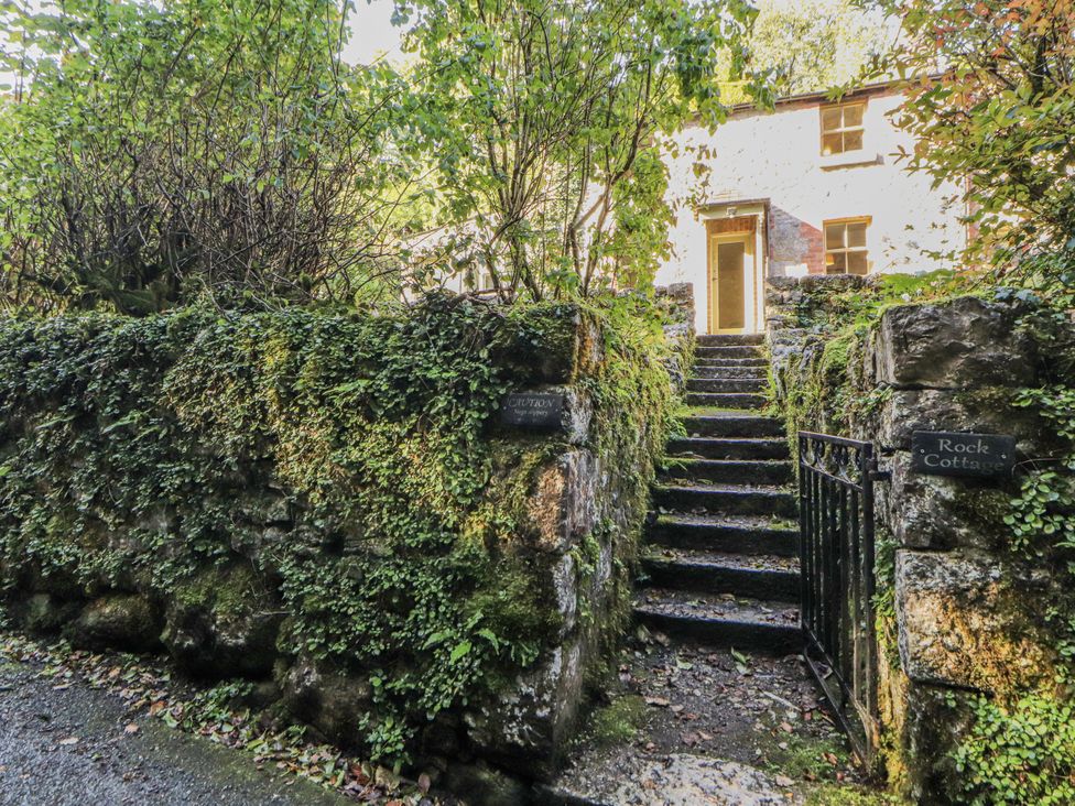An outdoor area with steps leading to a house at Rock Cottage in Milnthorpe