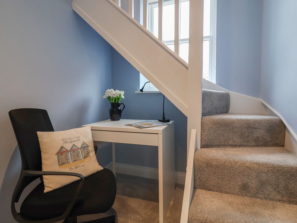 A stairwell with a desk and chair at The Nutshell in Aldeburgh