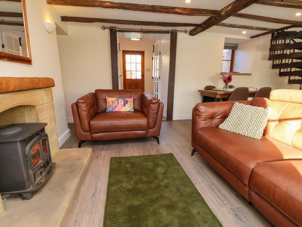 A living room with a sofa and fireplace at Dove Cottage in Sneaton near Ruswarp
