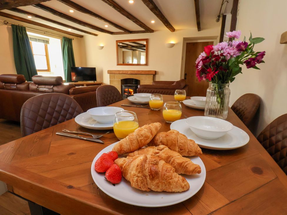 A dining room with a table set for breakfast at Dove Cottage in Sneaton near Ruswarp