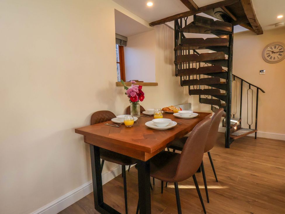 A dining room with a table set for breakfast at Dove Cottage Sneaton near Ruswarp