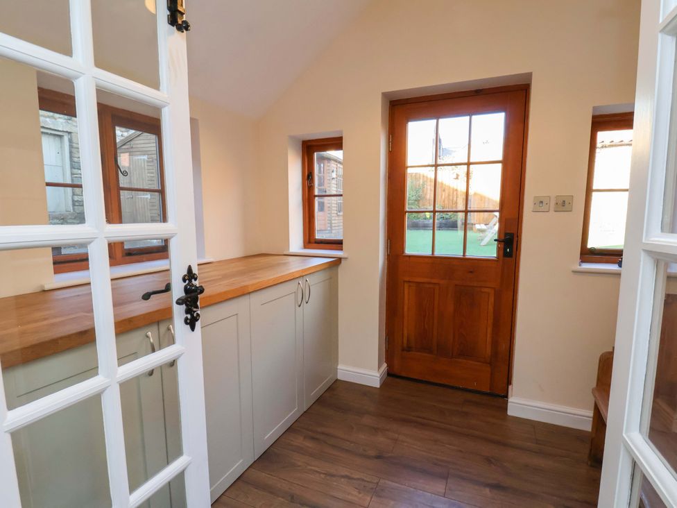 A kitchen with a countertop and cabinets at Dove Cottage Sneaton near Ruswarp