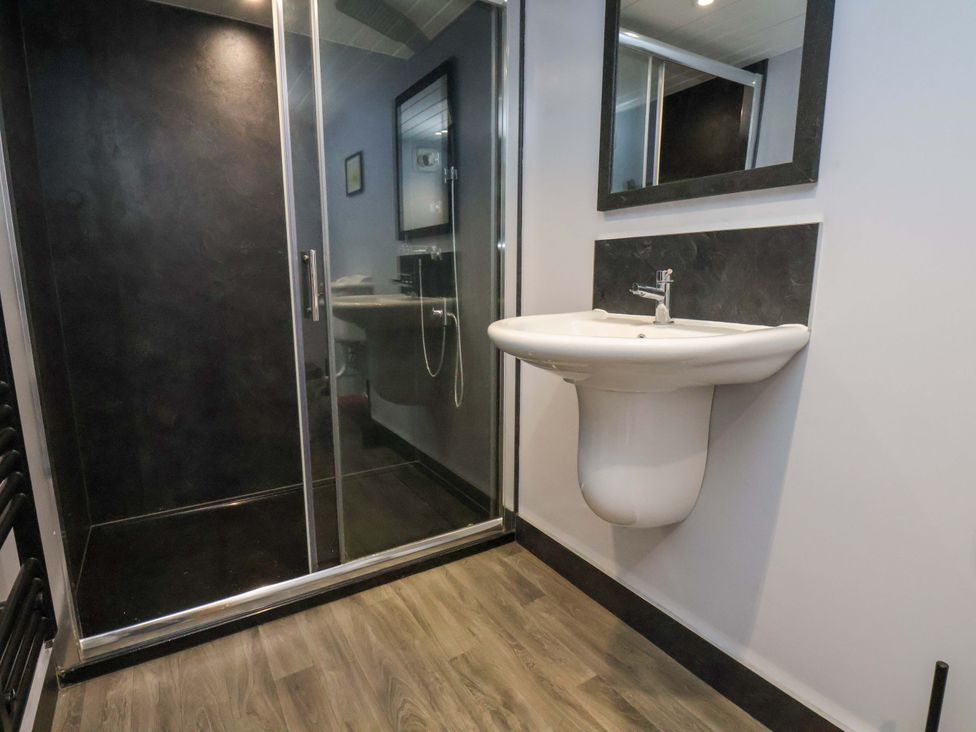A bathroom with a shower and a sink at Dove Cottage in Sneaton near Ruswarp
