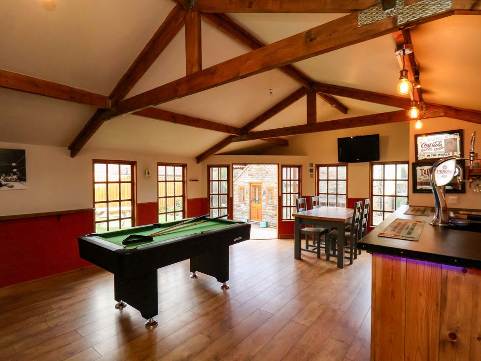 A game room with a pool table and dining table at Dove Cottage in Sneaton near Ruswarp
