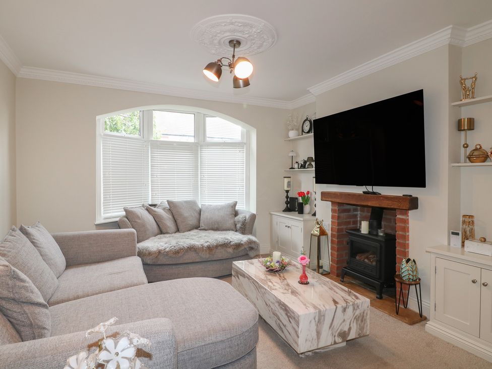 A living room with a sofa, coffee table, and television at No.12 Alexandra Avenue Sutton-in-Ashfield
