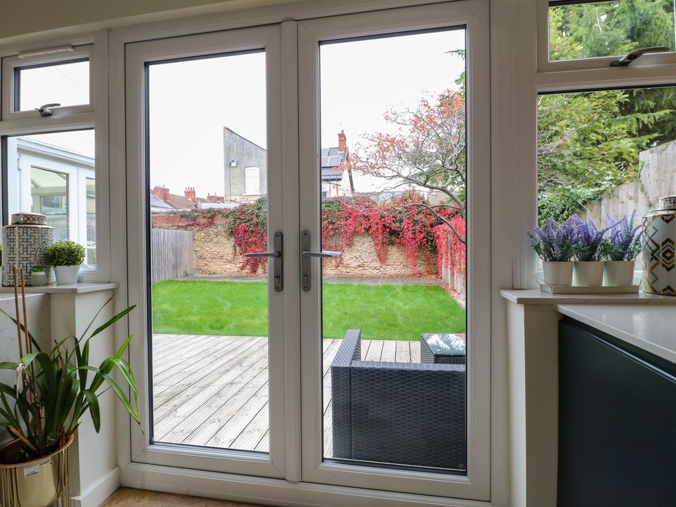 A view of a garden with glass doors and outdoor furniture at No.12 Alexandra Avenue Sutton-in-Ashfield