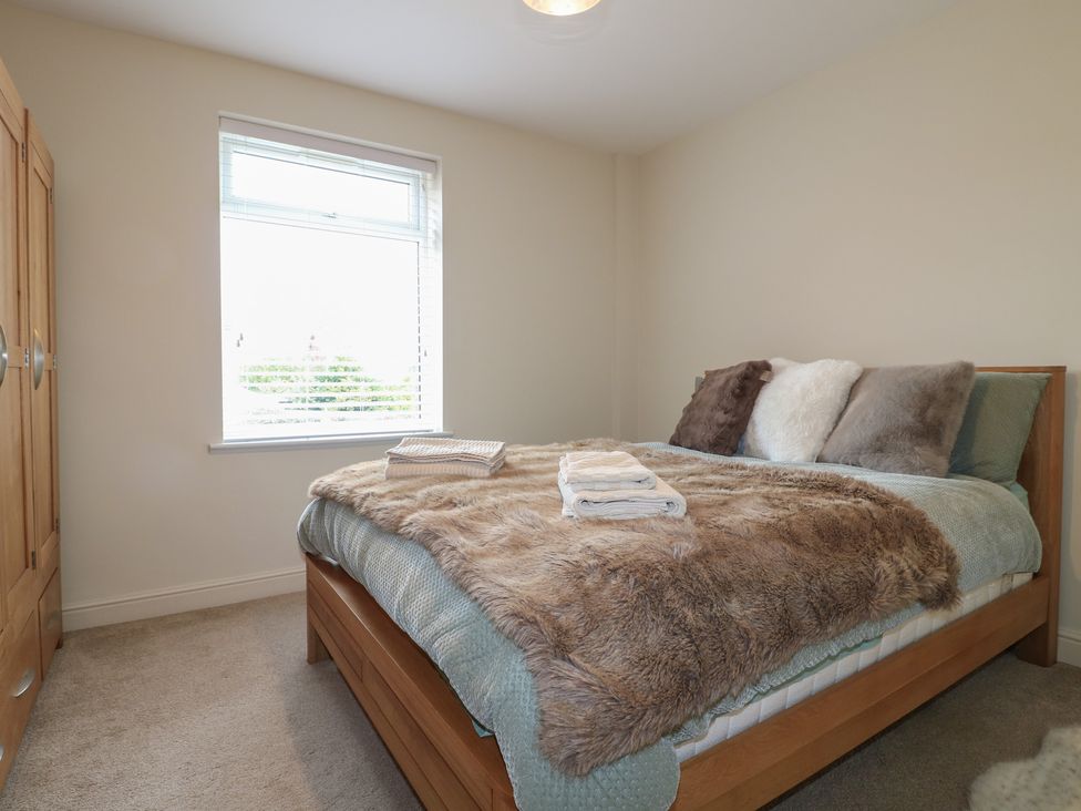 A bedroom with a bed and wardrobe at No.12 Alexandra Avenue Sutton-in-Ashfield