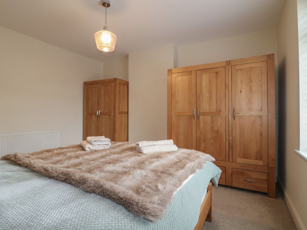 A bedroom with a bed and two wardrobes at No.12 Alexandra Avenue Sutton-in-Ashfield