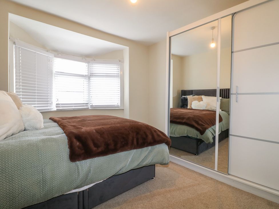 A bedroom with a bed and a window at No.12 Alexandra Avenue Sutton-in-Ashfield