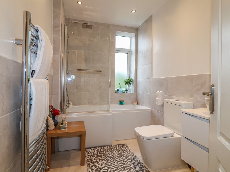 A bathroom with a bathtub and shower at No.12 Alexandra Avenue Sutton-in-Ashfield