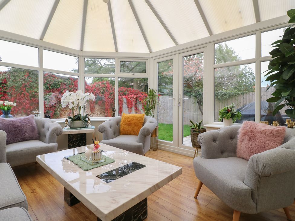 A conservatory with seating and a coffee table at No.12 Alexandra Avenue Sutton-in-Ashfield