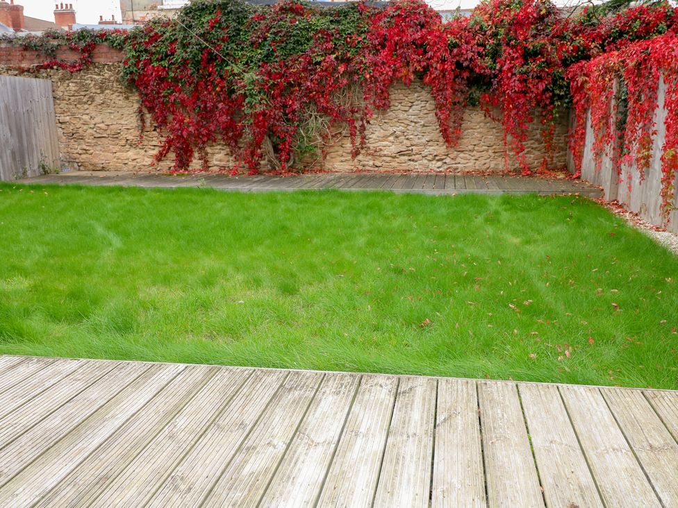 A garden with grass and a wooden deck at No.12 Alexandra Avenue Sutton-in-Ashfield