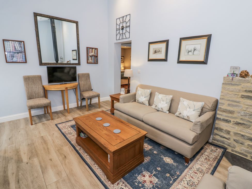 A living room with a sofa and coffee table at Lily Stables near Bampton, Oxfordshire