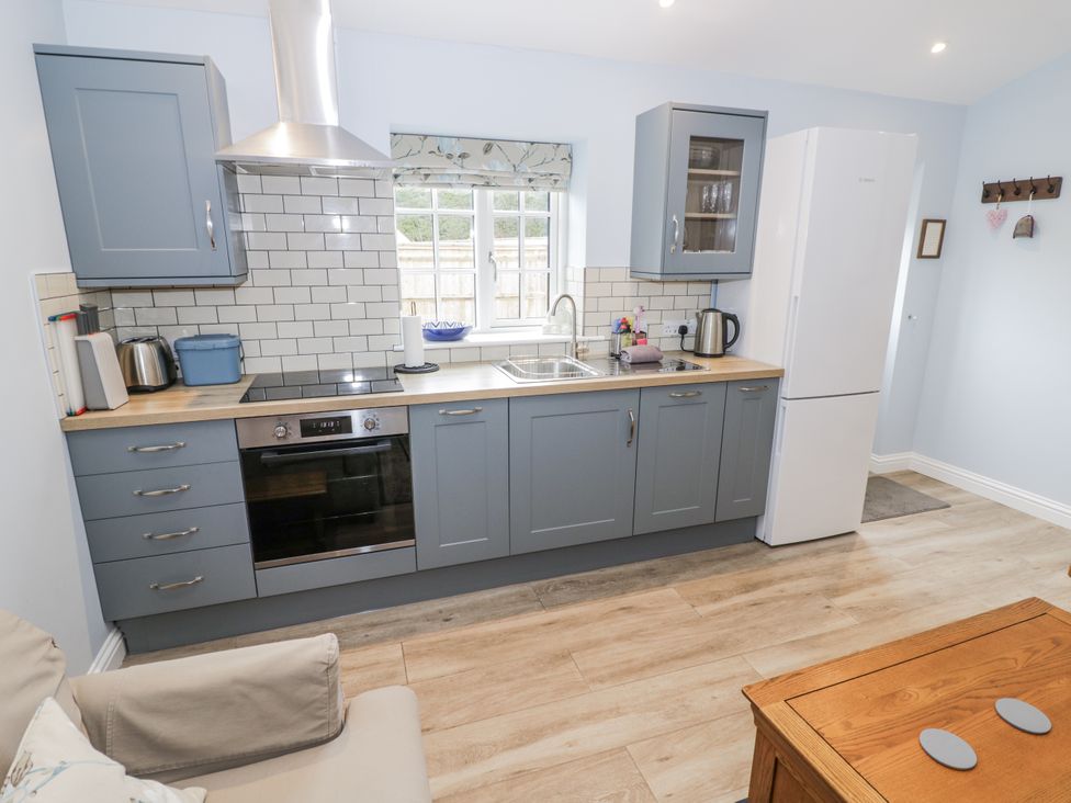 A kitchen with cabinets and appliances at Lily Stables Black Bourton near Bampton Oxfordshire