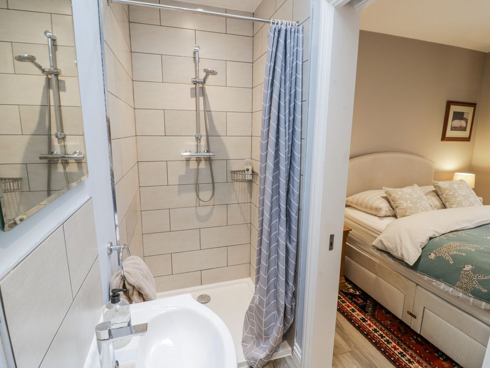 A bathroom with a shower and a sink at Lily Stables, Black Bourton near Bampton, Oxfordshire