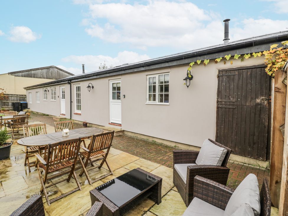 A garden area with seating and tables at Lily Stables in Black Bourton near Bampton, Oxfordshire