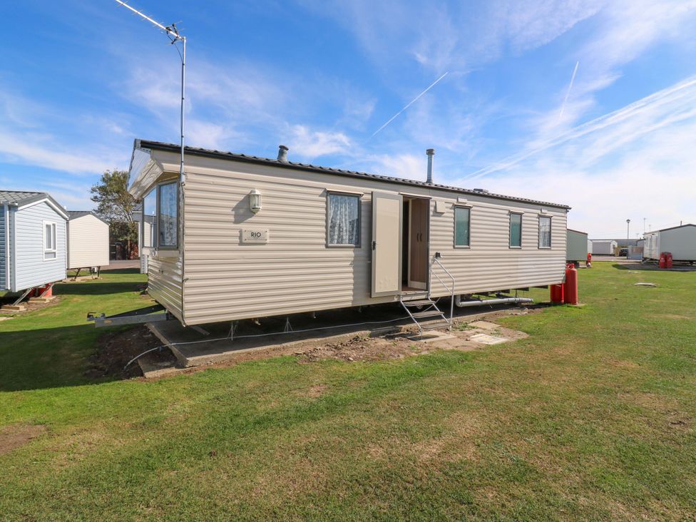 A caravan with windows and a door at Luisa Family Caravan St. Osyth