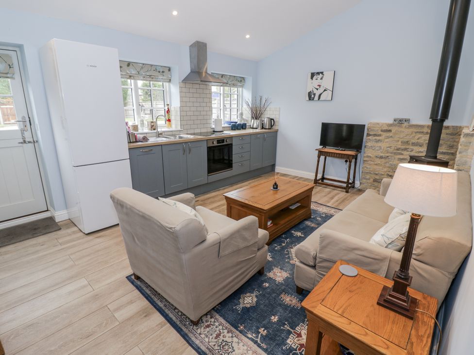 A kitchen with fridge and oven at Rose Stables Black Bourton near Bampton